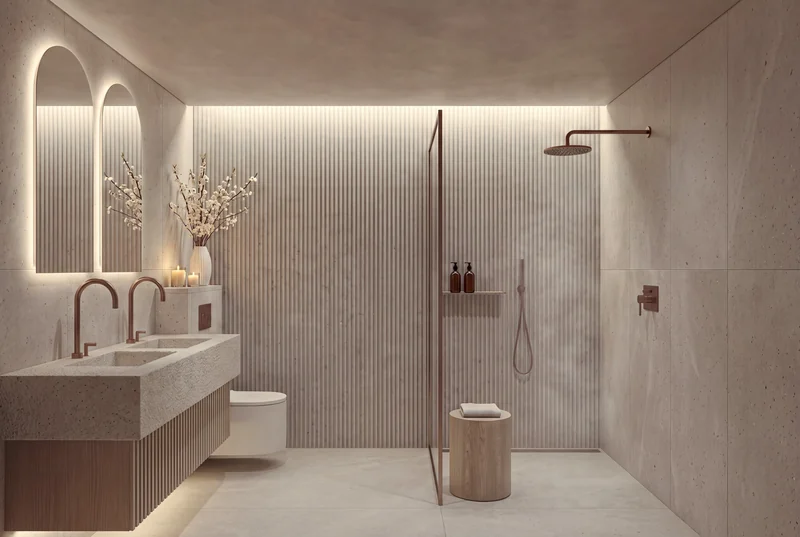 A fluted limestone bathroom with arched mirrors