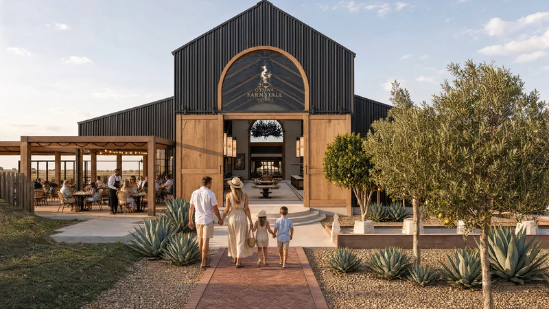 The black barn with its arched entrance and a pergola restaurant terrace full of guests