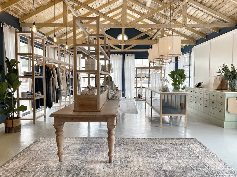 The Deidré & Co shop: reclaimed-oak fittings and a long table under exposed timber trusses